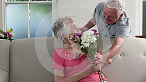 Old man surprising his wife with gifts