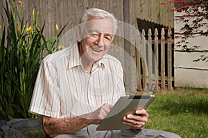 Old man with tablet computer