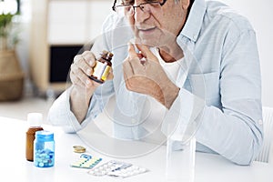 Old man taking pills