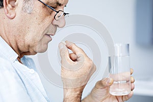 Old man taking pills