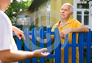 Old man talking with his neighbour