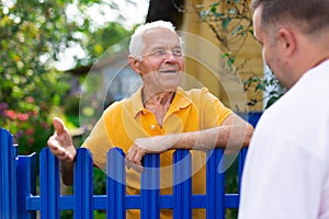 Old man talking with his neighbour