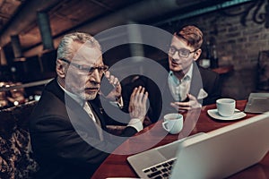 Old Man talking on Phone on Business Meeting