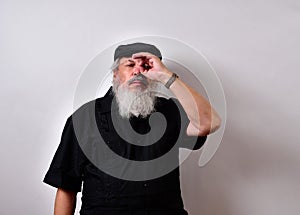 Old man using his hand as a pretend telescope