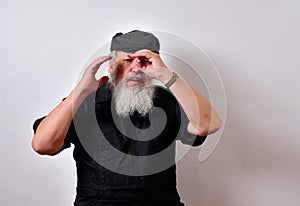 Old man using his hand as a pretend telescope
