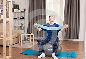 Old man using resistance band