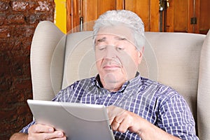 Old man using tablet.