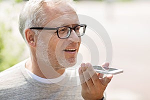 Old man using voice command recorder on smartphone