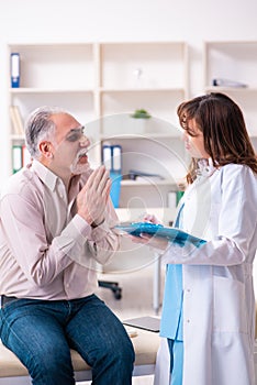 Old man visiting young female doctor for plastic surgery