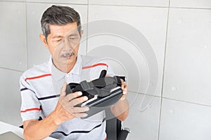 Old man in vr reality glasses of virtual reality with playing game