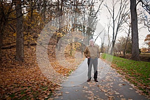 Old Man Walking on a Trail