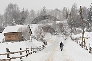 Old Man Walking through the Village in Winter