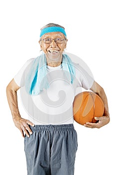 Old man wear sportswear while holds a basketball