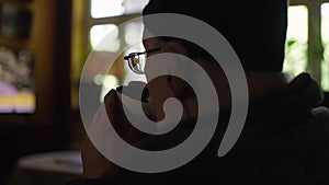 Old man in a wheelchair watching tv in the livingroom at home