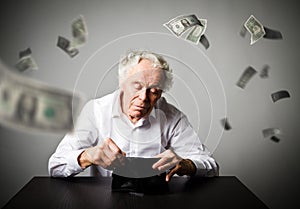 Old man in white and empty wallet. Accounting and taxes. Falling