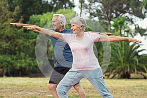 Old man and woman doing stretching exercise