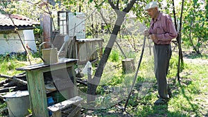 Old man working in his rural garden