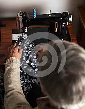 Old man working at the sewing machine