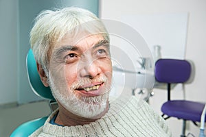 Old man with yellow teeth.