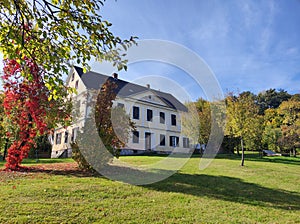 Old manor house in autumn public landscape park