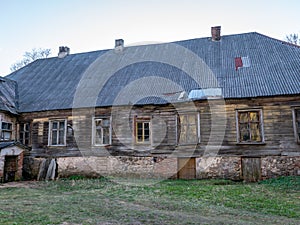 Old manor house surrounded by trees, partially inhabited