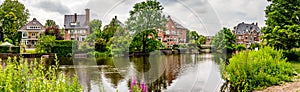 Old mansion with little bridge, amsterdam on a river panorama