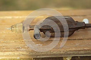 Old manual mechanical vintage retro drill on the workbench