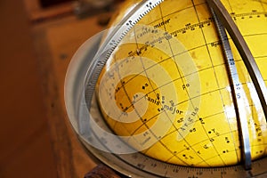 Old map of nocturnal sky on a globe photo