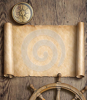 Old map scroll with compass and steering wheel on wood table. Adventure and travel concept. 3d illustration.