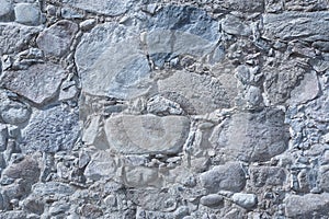 Old masonry wall of natural stones different sizes