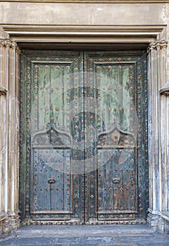 Old massive church door of the catholic church.