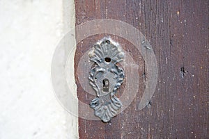 Old massive door with decorative door handle and lock, all still functional