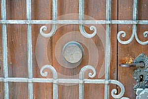 Old massive door with decorative door handle and lock, all still functional