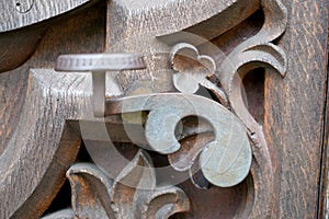 Old massive door with decorative door handle and lock, all still functional