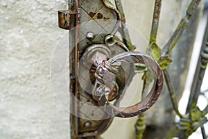 Old massive door with decorative door handle and lock, all still functional