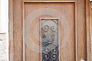 Old massive door with decorative door handle and lock, all still functional