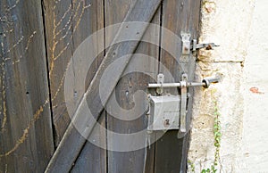 Old massive door with decorative door handle and lock, all still functional