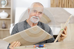 old master carpenter working in woodwork or workshop