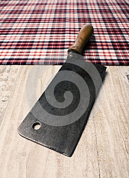 Old meat cleaver on a table