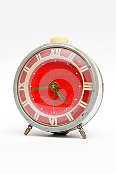 Old mechanical alarm clock on white background