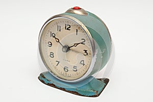 Old mechanical alarm clock on white background