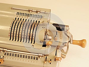 Old mechanical table top calculator with sliders and hand crank