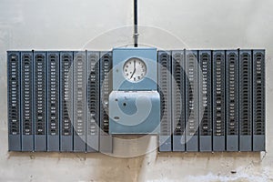 An old mechanical timeclock in an old abandoned factory