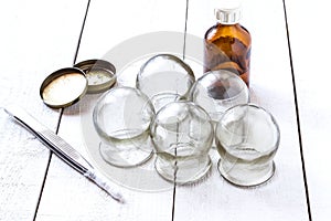 Old medical cupping glass, the alcohol, petrolatum and tweezers photo