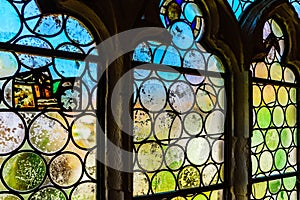 Old medieval colorful leaded-pane windows in gothic style