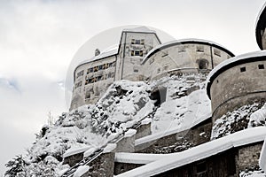 Old medieval european unassailable fortress or castle on hill at alpine austrian Kufstein city covered with big snow layer after