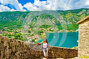 Old Medieval fortifications ruins and hiking woman on ladder Montenegro