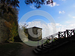 Old medieval grey stone Mikhailovskaya tower in the Pskov city, Russia in the bright autumn day