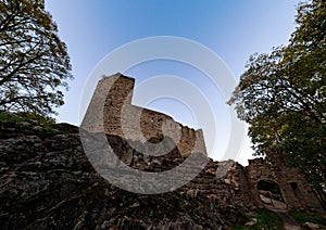 Old medieval hilltop castle Bernstein in Alsace. The ruins of a historic fort are built on a cliff