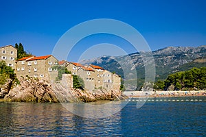 Old medieval houses on rock in sea, Balkans, Mediterranean
